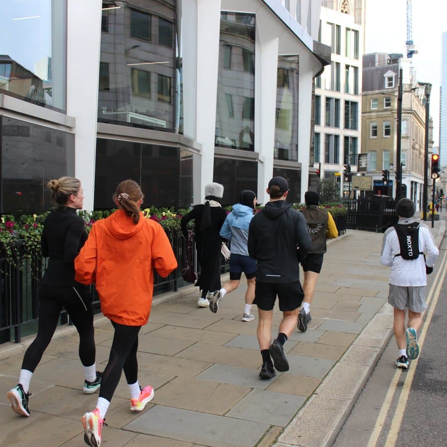 A group of runners heading through the City of London together on an early morning run